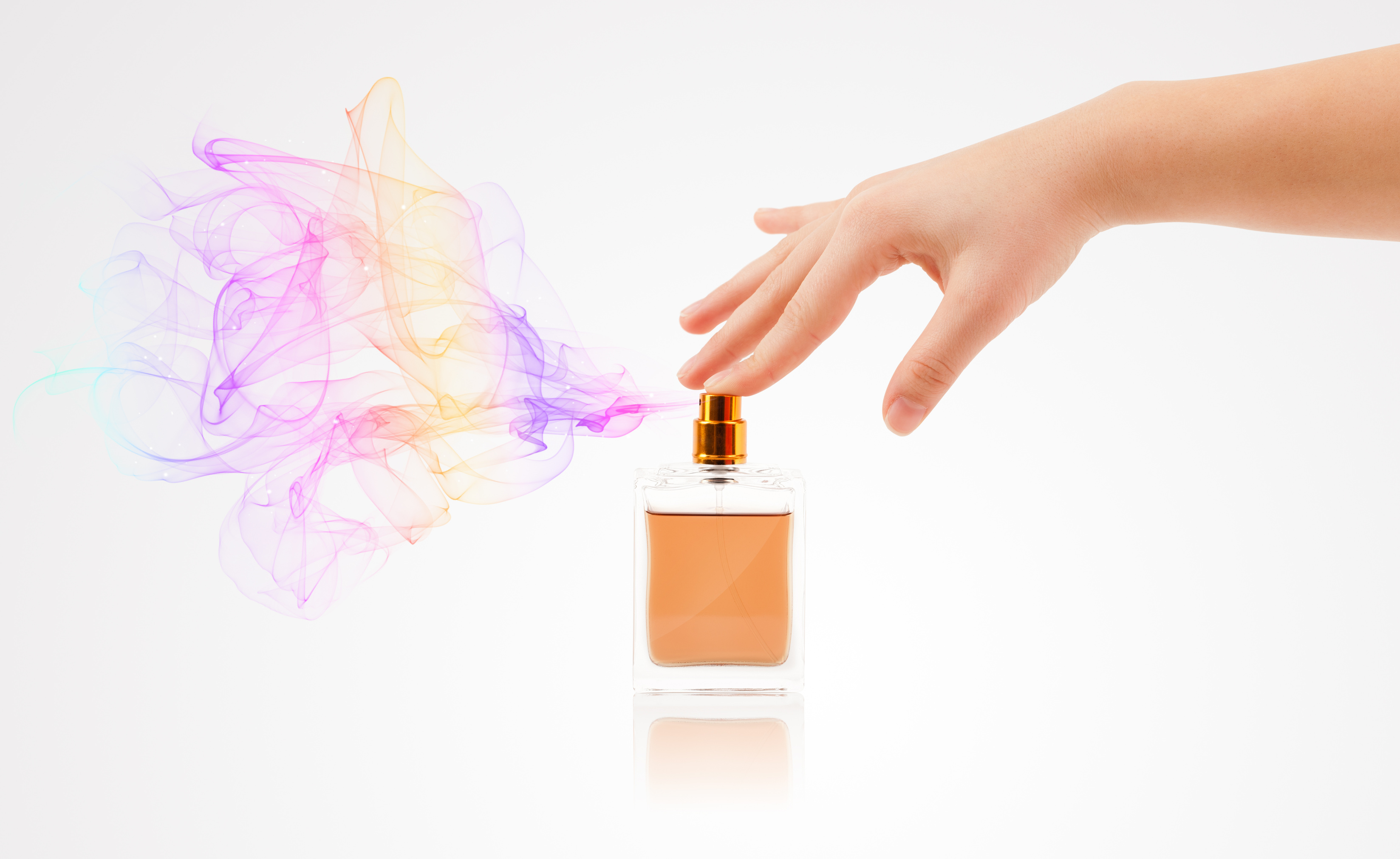 woman hands spraying perfume